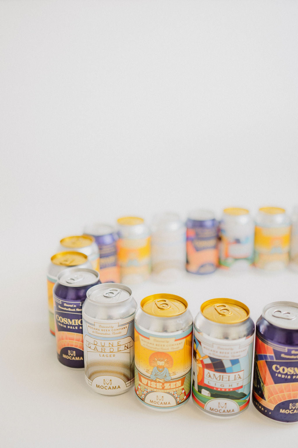 A colorful gathering of Mocama cans, including Cosmico, Dune Garden, Wise-Zen and Amelia Light