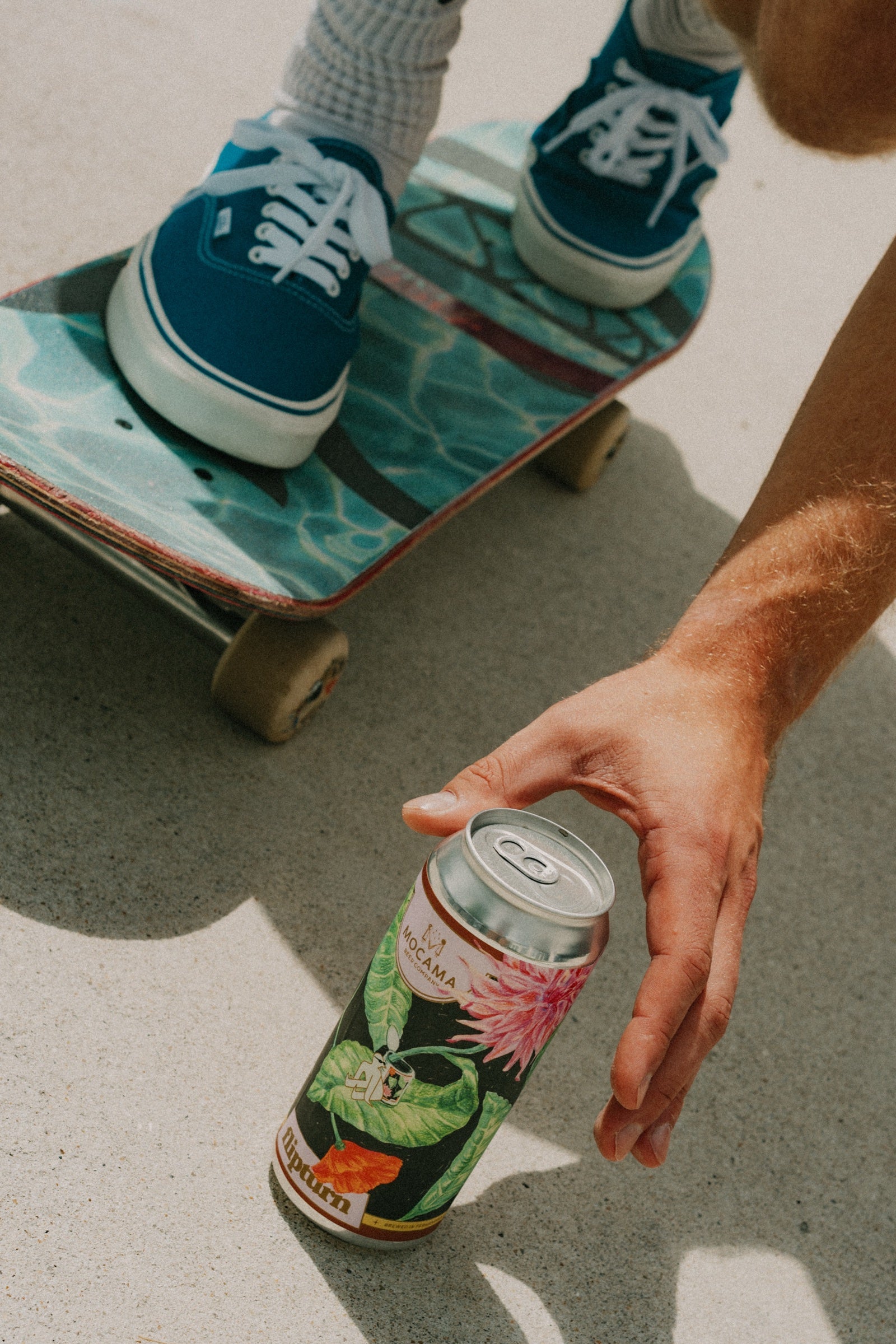 A flipturn can beside a skateboard